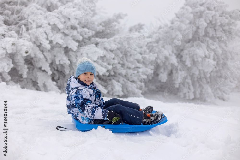 Sweet happy children, brothers, playing in deep snow in forest, frosted trees and beautiful landscape Sweet happy children, brothers, playing in deep snow in forest, frosted trees and beautiful landscape