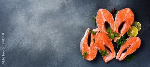 Panel kuchenny z motywem Salmon steaks. Set of raw salmon steaks on gray textured background. Top view. Wide banner.