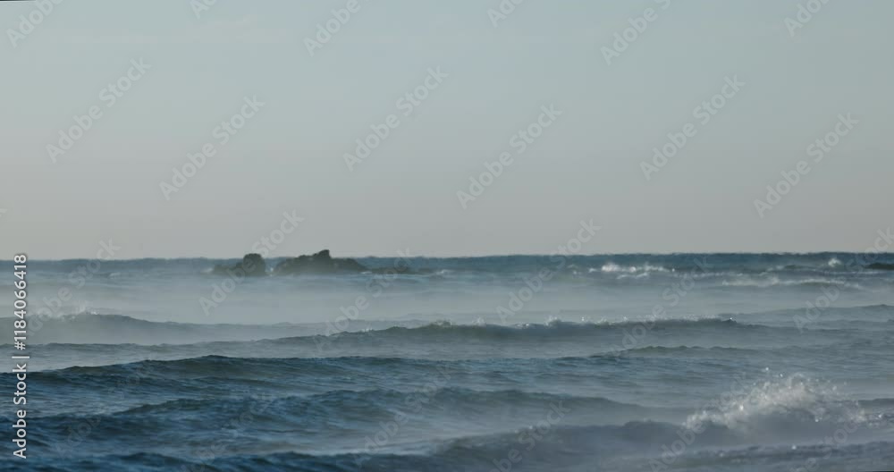 Sea sunrise with mist over rolling waves to the beach shore, beautiful seascape morning