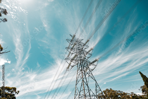 Electricity pylon with dramatic clouds and blue sky, symbolizing power and energy. photo