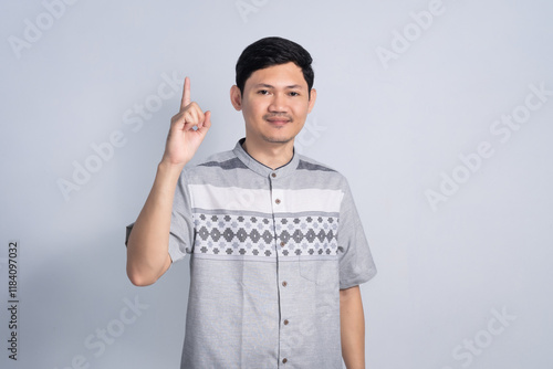 Muslim man pointing finger for Ramadan with Smile expression on isolated white background