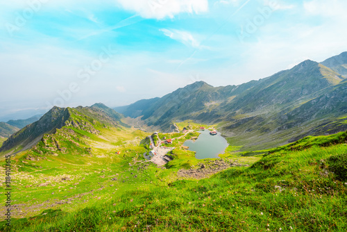 Hiking in Fagaras mountains on Iezerul Caprei peak over Transfagarasan serpentine road carpathian mountains. Mountains landscape photo