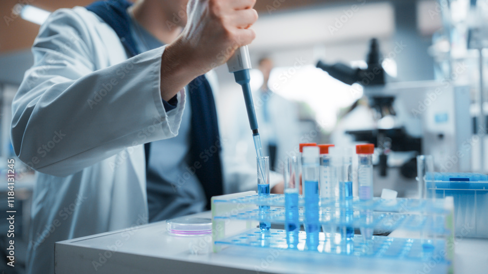 Medical Research Laboratory: Scientist Using Micropipette to Analyze Samples Under Microscope. Advanced Scientific Lab for Medicine, Biotechnology, Microbiology Development Medical Research Laboratory: Scientist Using Micropipette to Analyze Samples Under Microscope. Advanced Scientific Lab for Medicine, Biotechnology, Microbiology Development