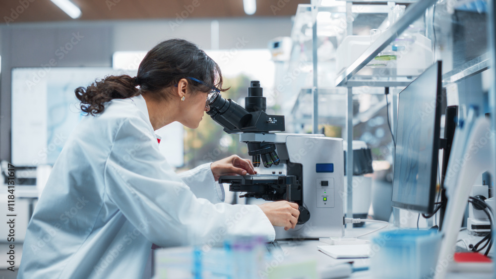 Portrait of a Beautiful Caucasian Student Working on a Research Project in College. Medical Research Scientist Looking at Biological Samples Under a Microscope in an Applied Science Laboratory Portrait of a Beautiful Caucasian Student Working on a Research Project in College. Medical Research Scientist Looking at Biological Samples Under a Microscope in an Applied Science Laboratory