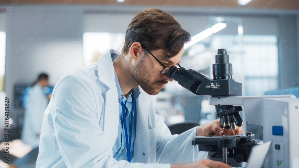 Portrait of a Handsome Scientist Analyzing Genetic Samples Under Microscope. Advanced Scientific Medical Research Laboratory for Microbiology Products Development Portrait of a Handsome Scientist Analyzing Genetic Samples Under Microscope. Advanced Scientific Medical Research Laboratory for Microbiology Products Development