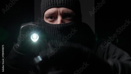 Gloved person with flashlight in dark setting