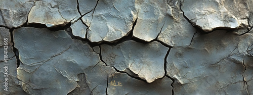 A cracked old brick wall with deep crevices and weathered paint. A distressed surface perfect for creating a vintage or urban industrial look.