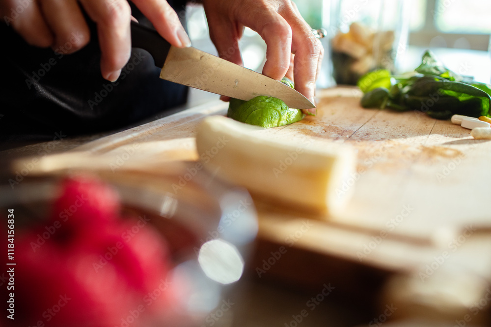 Close up woman hands cutting fresh ingredients for smoothie on a wooden board Close up woman hands cutting fresh ingredients for smoothie on a wooden board