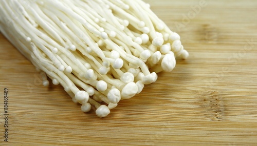 Enoki mushrooms on the cutting board. photo