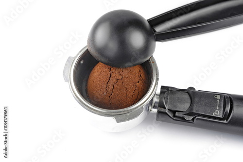 holder filled with ground coffee and black spoonholder filled with ground coffee and black spoon isolated on white background. photo