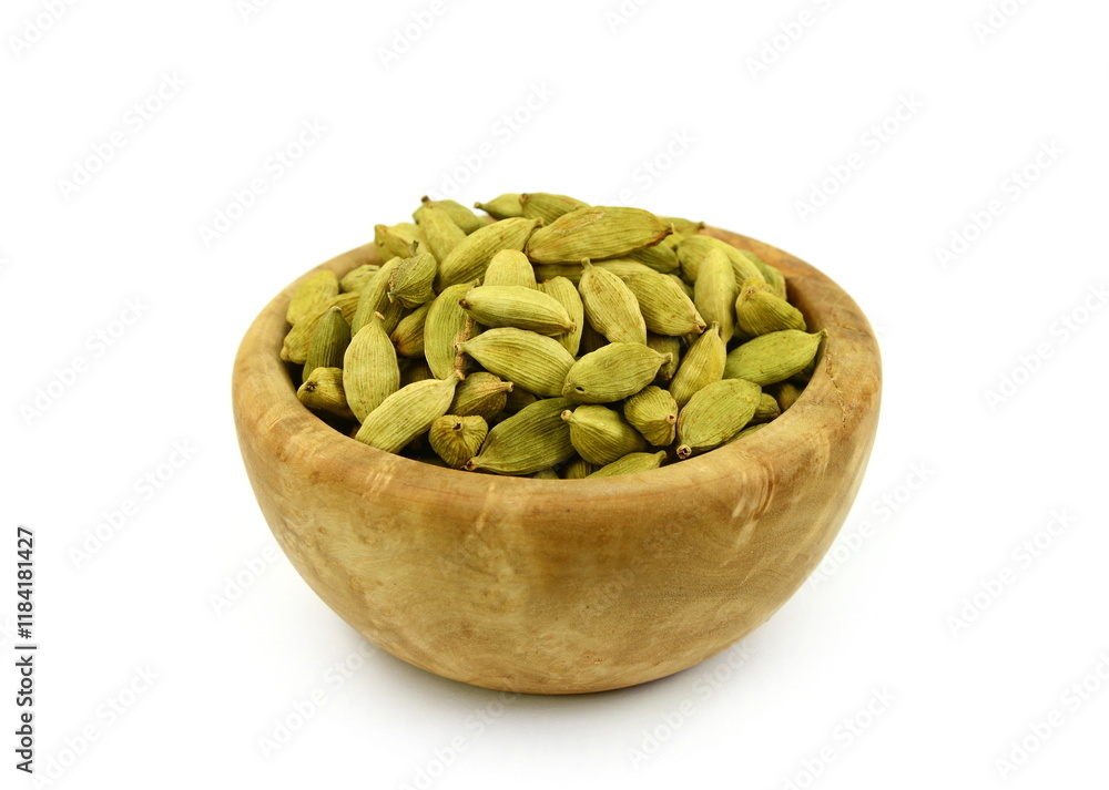 Pile of cardamom or cardamon seeds spice in a wooden bowl isolated on white background. Dried cardamom seeds isolated on white Pile of cardamom or cardamon seeds spice in a wooden bowl isolated on white background. Dried cardamom seeds isolated on white