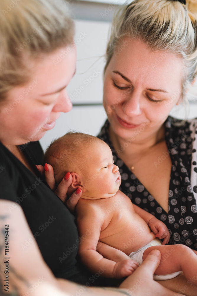 Women gay couple having fun with their baby daughter at home. Women gay couple having fun with their baby daughter at home.
