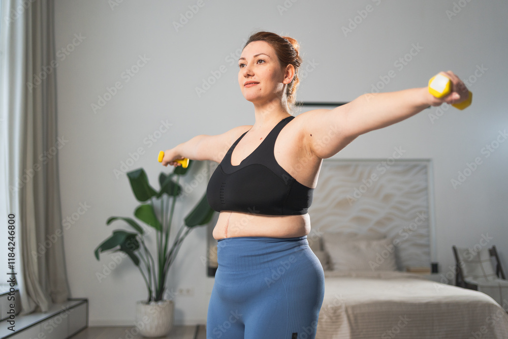 Fitness workout training. Woman picking up dumbbells. Plus size female doing sports exercise at home indoor. Girl in sportswear have workout weight training for weight loss. Sport and fitness Fitness workout training. Woman picking up dumbbells. Plus size female doing sports exercise at home indoor. Girl in sportswear have workout weight training for weight loss. Sport and fitness