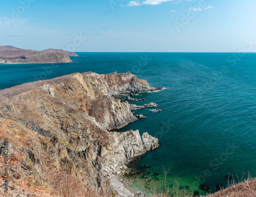 View of the vastness of the Pacific Ocean from the high seashore. High cliffs on the shore of the Pacific Ocean. photo