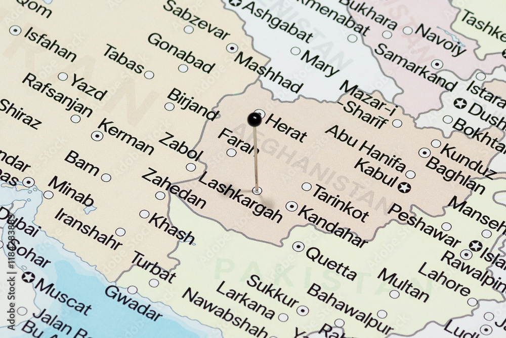 Fototapeta premium Macro photo of a black pin needle into Lashkargah city of Afghanistan political map 
