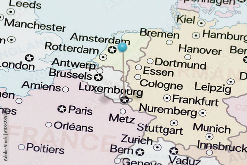 Macro photo of a light blue pin needle into Luxembourg city of Grand Duchy of Luxembourg political map 
