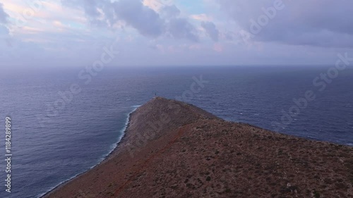 Aerial view of cape tainaron lighthouse at sunrise overlooking the serene mediterranean sea and rugged coast, Lagia, Greece. photo