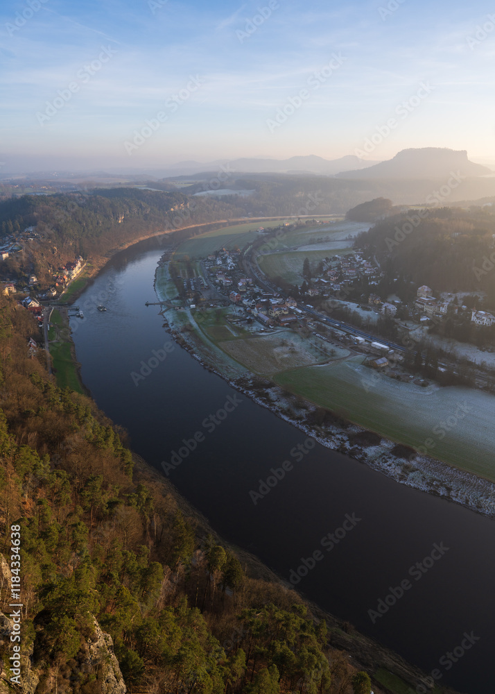 Winter sunset landscape of Saxon Switzerland in Germany and view from height of Bastei bridge. Sandstone mountains on Elbe River. Popular tourist destination. Winter sunset landscape of Saxon Switzerland in Germany and view from height of Bastei bridge. Sandstone mountains on Elbe River. Popular tourist destination.