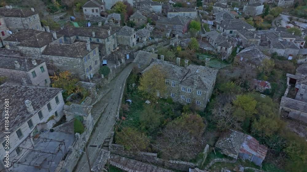 Aerial view of picturesque village with stone buildings and cobblestone streets at sunrise in autumn, Papigo, Greece. Aerial view of picturesque village with stone buildings and cobblestone streets at sunrise in autumn, Papigo, Greece.