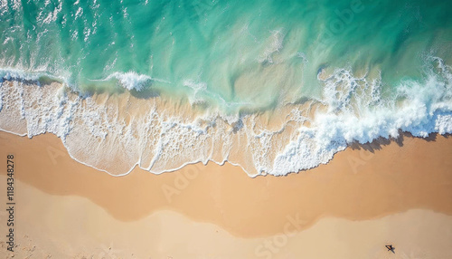 Aerial view of turquoise ocean wave reaching the coastline. Beautiful tropical beach from top view. Andaman sea in Indonesian. Summer holiday vacation concept