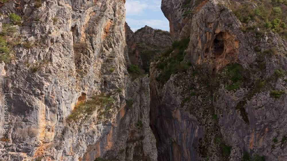 Aerial view of portitsa ancient stone bridge over a dramatic gorge with rugged cliffs and beautiful natural landscape, Spileo, Western Macedonia, Greece. Aerial view of portitsa ancient stone bridge over a dramatic gorge with rugged cliffs and beautiful natural landscape, Spileo, Western Macedonia, Greece.
