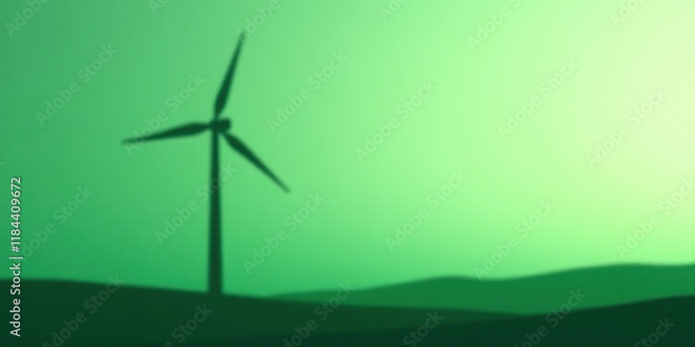 Obraz premium Clean energy silhouette of a wind turbine on a green landscape