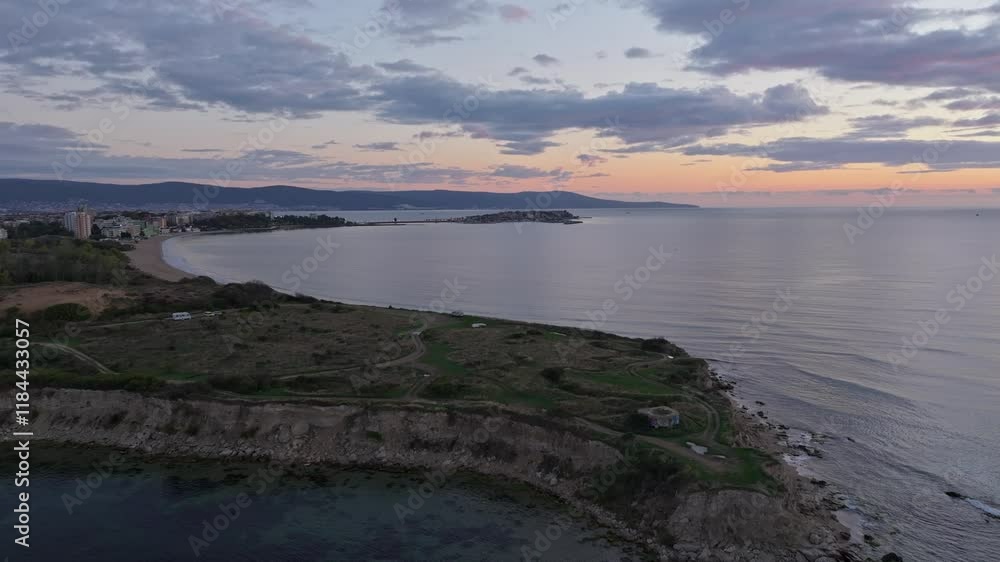 Aerial view of tranquil sunrise over the Black Sea with picturesque coastline and serene beach, Nesebar, Bulgaria. Aerial view of tranquil sunrise over the Black Sea with picturesque coastline and serene beach, Nesebar, Bulgaria.