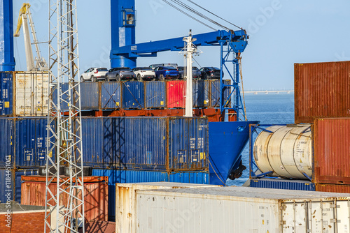 Obraz na płótnie Cargo and tank containers stacked and with vehicles on top stacked at w salonie