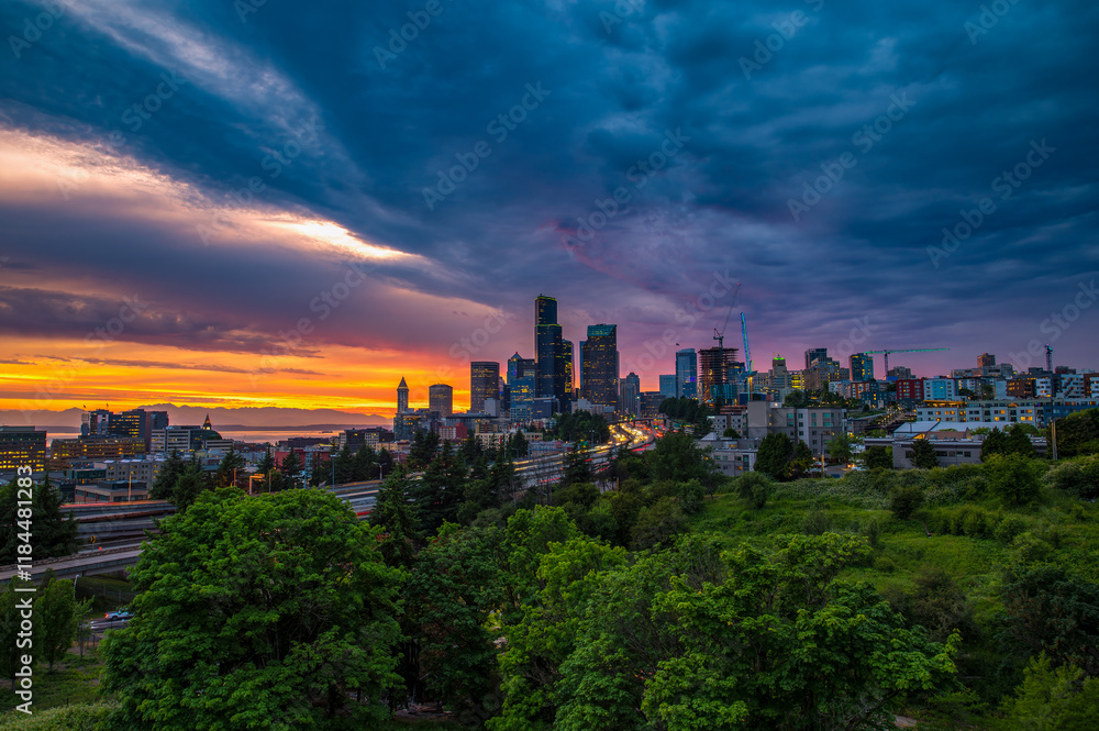Vibrant sunset over Seattle skyline with dramatic clouds, captured from Dr. Jose Rizal Bridge, featuring lush greenery in the foreground. Vibrant sunset over Seattle skyline with dramatic clouds, captured from Dr. Jose Rizal Bridge, featuring lush greenery in the foreground.