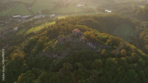 Aerial view of Castle Potstejn at sunrise surrounded by tranquil forest and picturesque hills, Potstejn, Czech Republic. photo