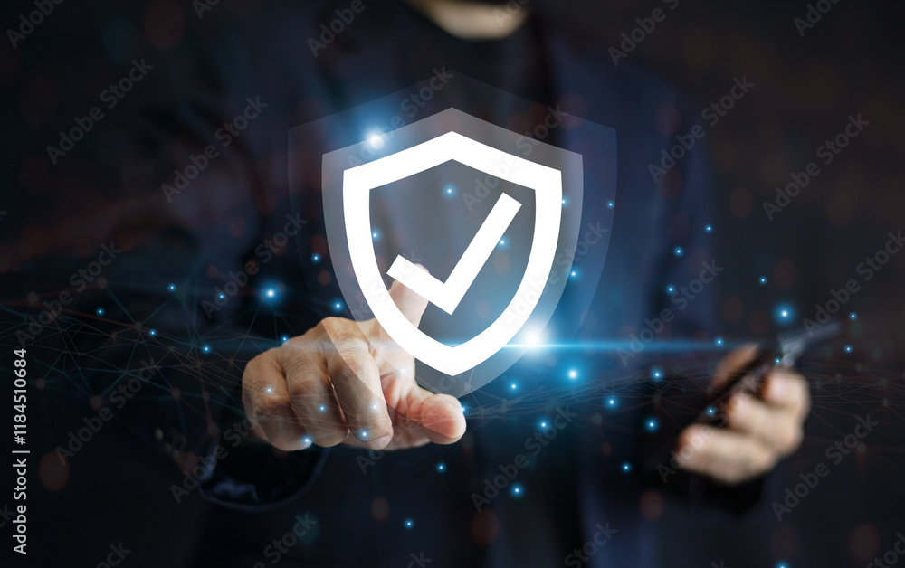 Businessman use mobile phone technology with advanced cyber security shield, ensuring the protection of sensitive data and securing the digital environment against potential threats.