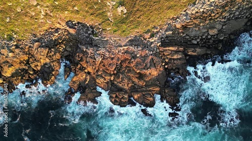 Aerial view of rugged rocky coast with crashing waves and dramatic cliffs, Monteferro Peninsula, Nigran, Spain. photo