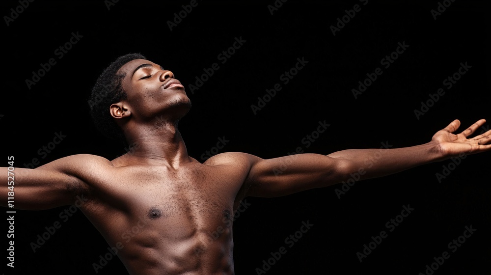Obraz premium Shirtless muscular man with arms outstretched, head tilted back, eyes closed, on black background.