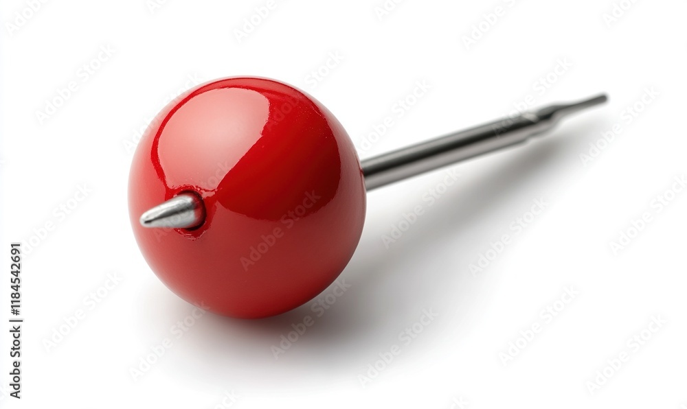 A shiny red ball with a sharp metal point, possibly a decorative or functional object. A shiny red ball with a sharp metal point, possibly a decorative or functional object.