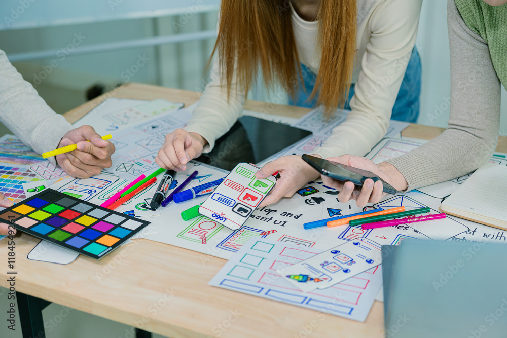 Fototapeta premium Application development UI UX web designer team is working together to develop a mobile responsive website with UI UX front end designer examples,