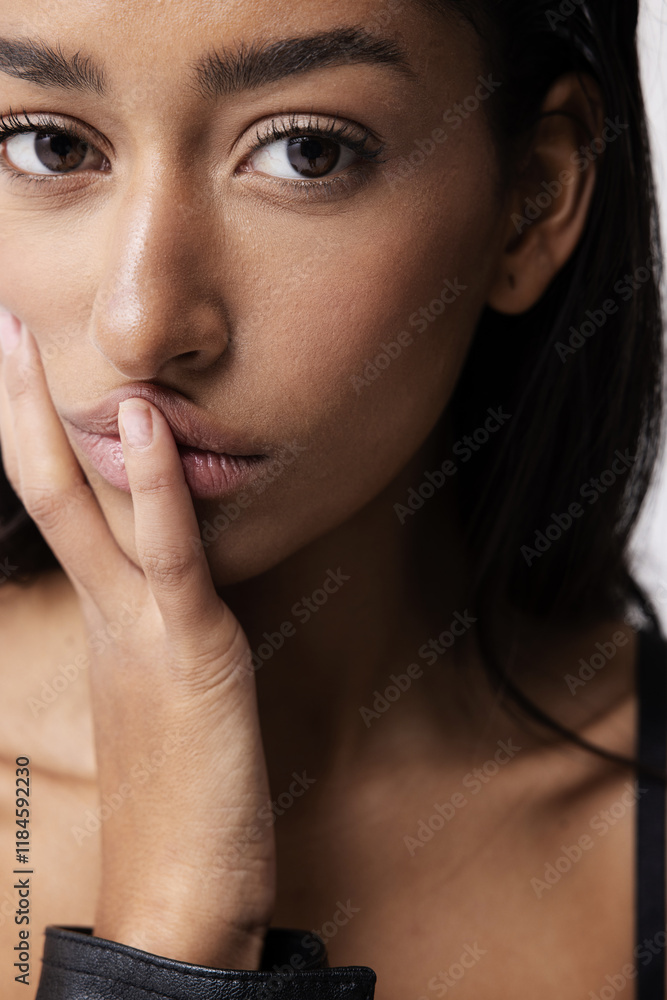Close-up studio portrait of beautiful Indian female model with perfect glowy skin. Vertical. Close-up studio portrait of beautiful Indian female model with perfect glowy skin. Vertical.