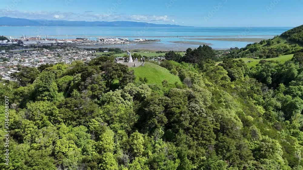 Aerial view of the Centre of New Zealand monument surrounded by lush forest and cityscape, Nelson, New Zealand. Aerial view of the Centre of New Zealand monument surrounded by lush forest and cityscape, Nelson, New Zealand.