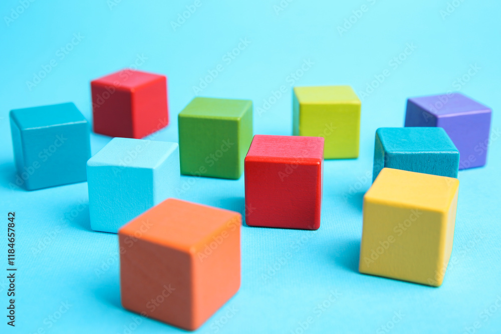 Many colorful cubes on light blue background Many colorful cubes on light blue background