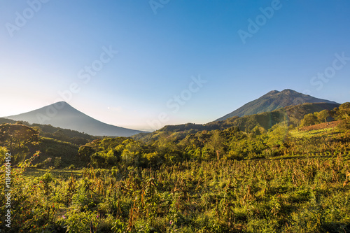 Panoramic view of agricultural fields on the slopes of the imposing Acatenango volcano and the Agua volcano in the background. photo