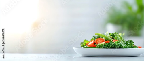 Fresh and vibrant salad with greens and cherry tomatoes on a white plate against a bright, blurred background.