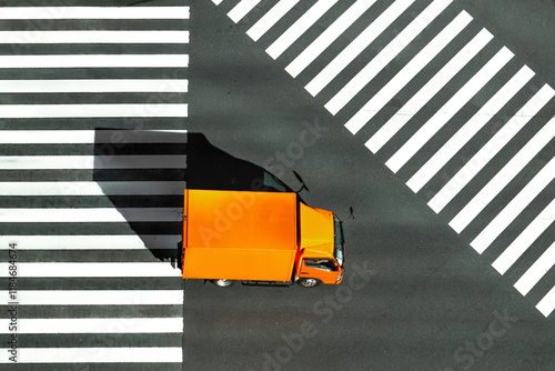 View of orange truck at zebra crossing with black and white lines, Yurakucho, Tokyo, Japan. photo