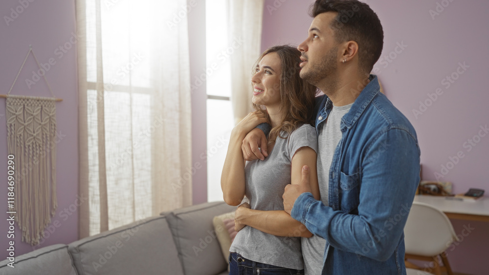 Happy couple smiling and embracing in a cozy living room Happy couple smiling and embracing in a cozy living room