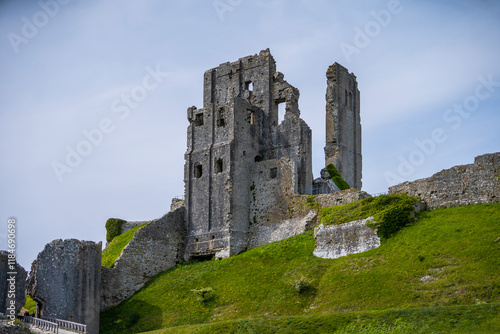 View of corfe castle ruins on purbeck hills surrounded by grass, Wareham, United Kingdom. photo