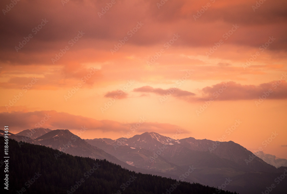 View of majestic sunset over the serene mountains with dramatic sky and clouds, Montvalezan, France. View of majestic sunset over the serene mountains with dramatic sky and clouds, Montvalezan, France.
