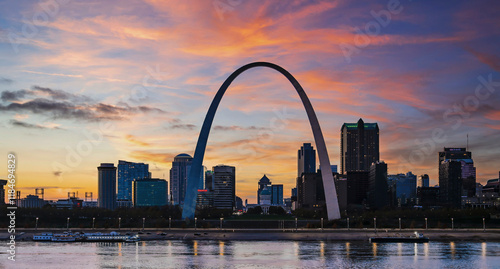 View of St Louis skyline at sunset with the iconic arch and riverfront, St Louis, United States.