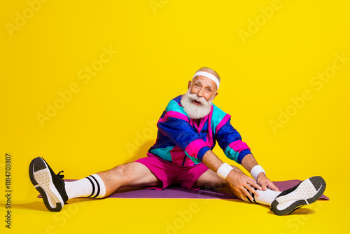 Full size photo poster of handsome granddad sportsman stretching legs excited wear trendy vintage sportswear isolated on yellow background photo