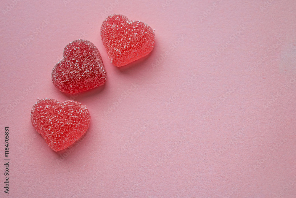 Fototapeta premium Three gummy hearts on a pink background with space for an inscription