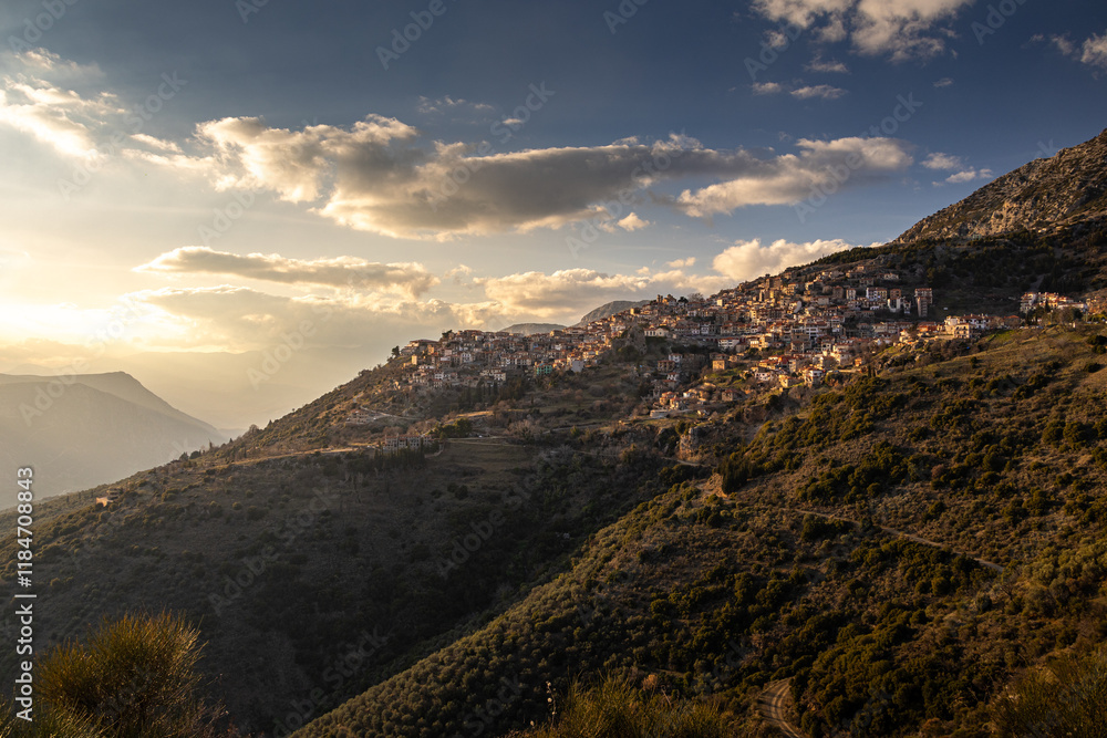 Sunset over Arachova city at Parnassus Mountain resort. Beautiful landscape with Arachova and its amazing architecture Greek constructions. Travel to Greece.