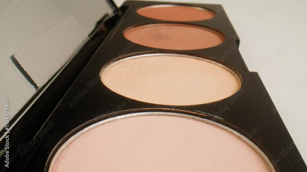 Multi Coloured Rainbow Make up Palette with Colourful make up brushes close up, macro in shop. 