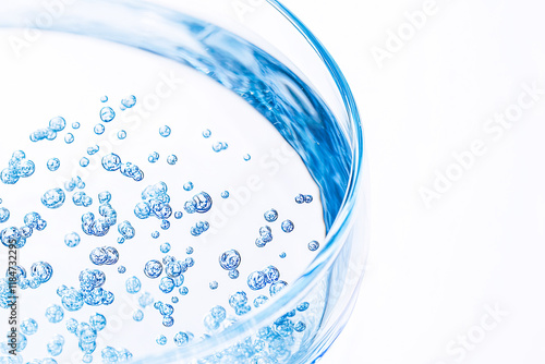 Purified Water in Laboratory Experiment, blue background photo